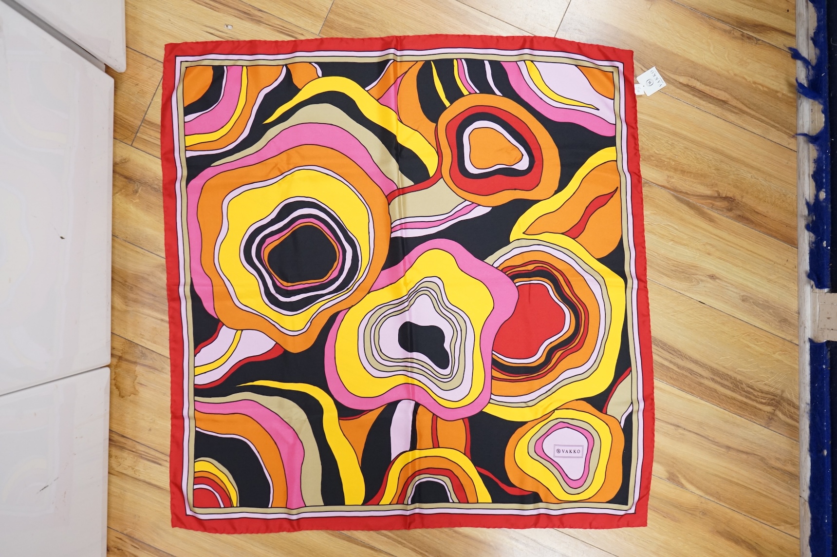 Three silk scarves comprising a Burberry check example, Christian Dior monogrammed and a Vakko abstract patterned example